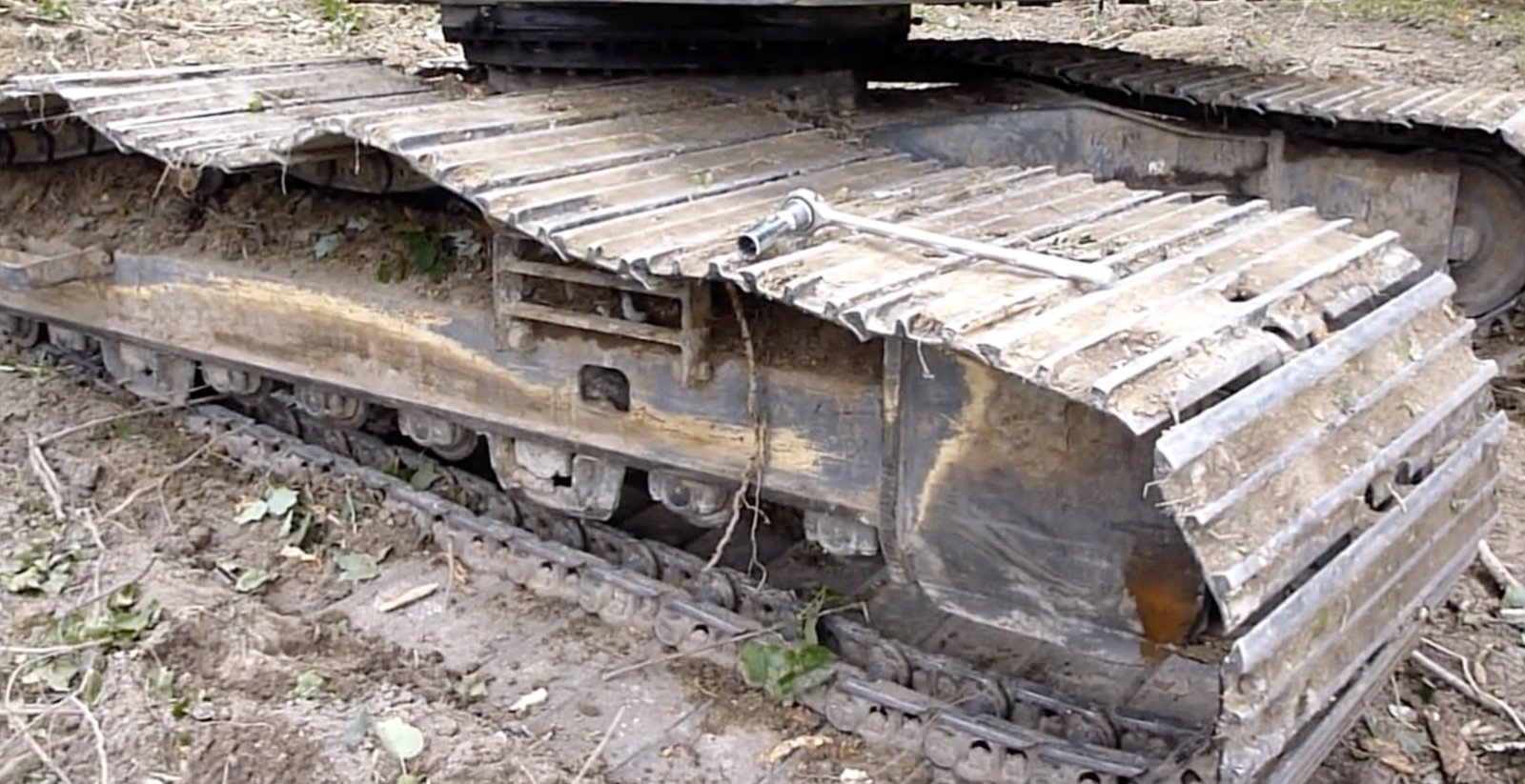 Loose, derailed excavator track showing abnormal condition